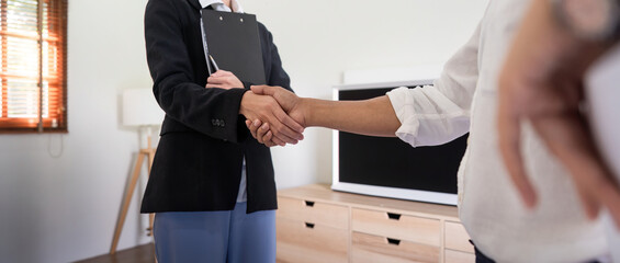 Couple asian handshake with a real estate agent after purchase a home