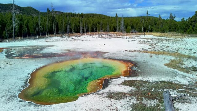 Opal Pool Morning Glory Grand Prismatic Spring West Yellowstone National Park Old Faithful Grand loop geysers scenic Wyoming Idaho mist steam thermal colorful yellow morning cinematic slowly pan left