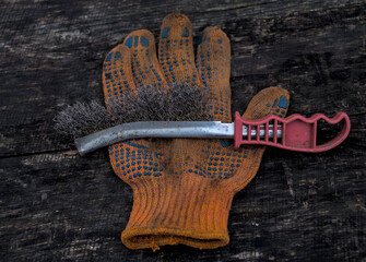 Photo of metal brush on used glove