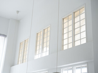 The tall vintage glass bay window, minimal style living room. Bright cafe or restaurant interior decoration with tables and chairs.