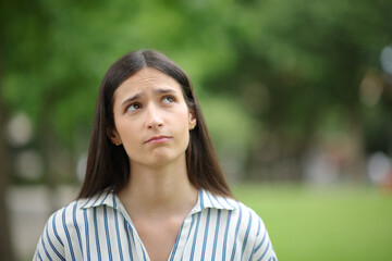 Worried woman thinking looking at side