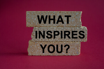 What inspires you symbol. Concept words What inspires you on brick blocks. Beautiful red background. Business motivational what inspires you concept. Copy space.