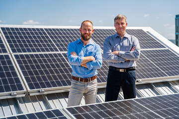Two businessmen exude confidence as they stand among rows of solar panels, ready to harness the power of the sun.