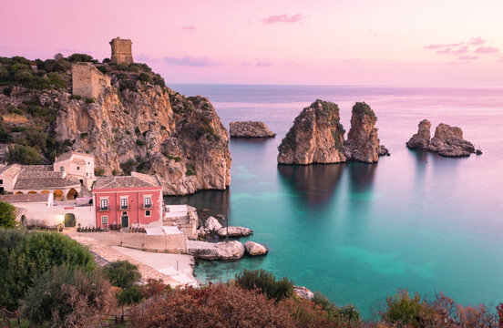 Italy, Sicily, Scopello, Coastal village and Tonnara di Scopello stack rocks at dusk