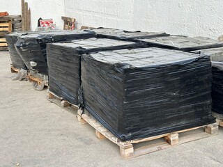 Lots of pallets with paving stones for road repairs