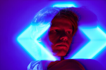 Portrait with long exposure. Young man, attractive guy posing in futuristic, digital projector...