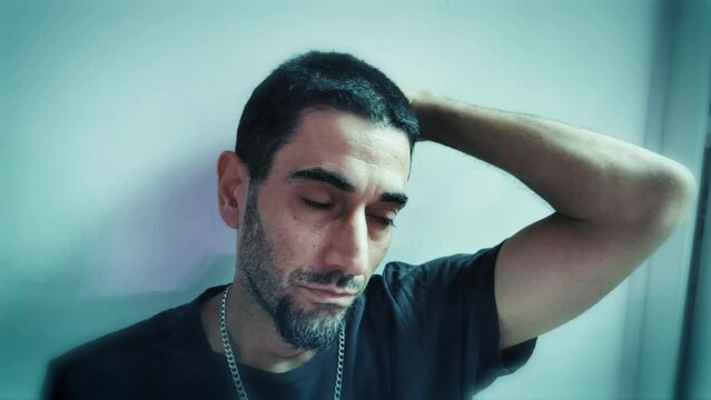 Young man in a regreting sad mood.