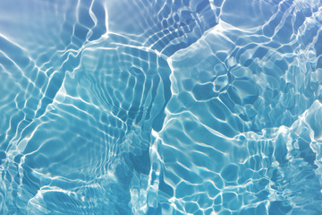  Water splash in the glass. bubbles in water. Blue water with ripples on the surface. Defocus...