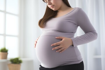 Pregnant Woman Holding Her Belly In Sportswear