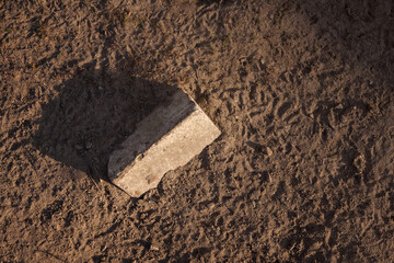 An old brick is lying on the ground