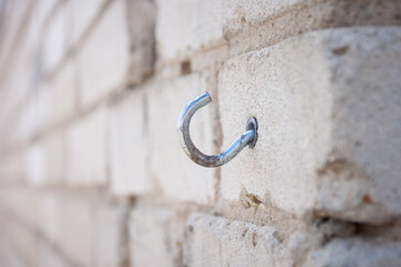 A metal hook (dowel) in a brick wall