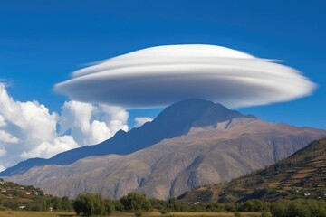 formation of a lenticular cloud over mountain peak