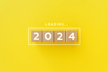 2024 New Year Loading. Loading bar with wooden blocks 2024 on yellow background. Start new year...