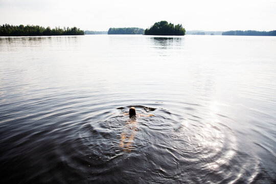 Girl swimming in Lake Nommen, Sweden