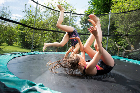 Happy girls playing on trampoline