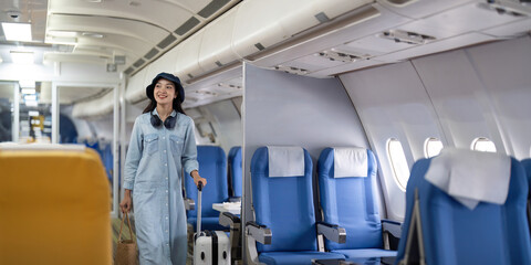 Young woman with a suitcase at the airplane