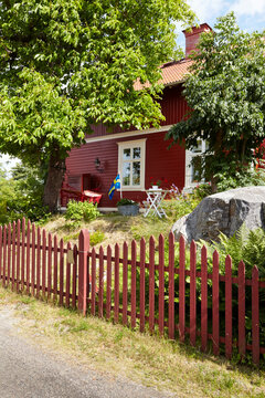 Picket fence and trees by house