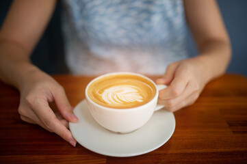 closeup hand drinking hot coffee, relax time