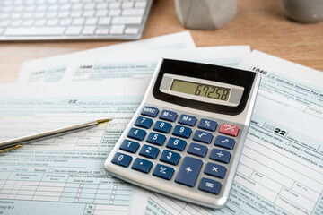 1040 Tax form documents with pen and computer keyboard on office desk