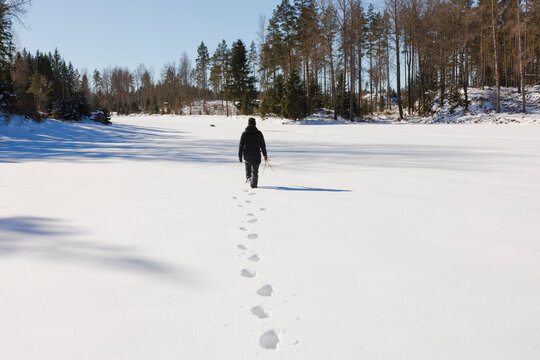 Footprints of woman walking in snow