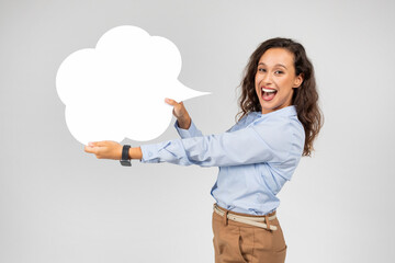 Shocked glad european woman in formal wear with open mouth hold abstract cloud for words and...