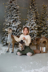Christmas card with smiling girl with deer and spruces.