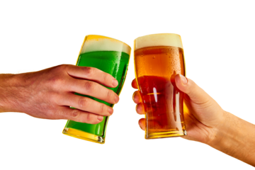 Cheers. Hands clinking green and lager foamy beer glasses isolated on transparent background. Concept of st patrick's day celebration, brewery, traditions, alcohol drinks, taste, Irish holiday