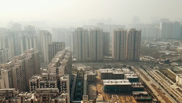 Aerial view of Greater Noida City in Uttar Pradesh, India. Construction of a multi-story Residence apartment building. Drone shot of modern City high-rise skyscraper buildings in India.