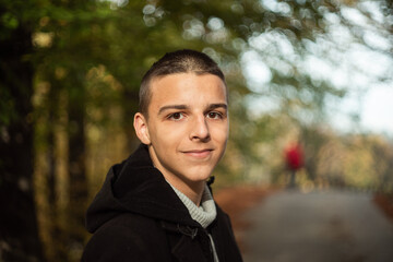 a 16-year-old teenager poses outside