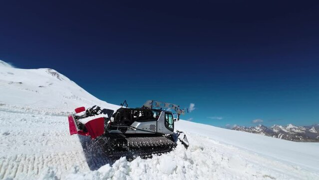Snow groomer at work. snowcat in the process of preparing trails on the mountain