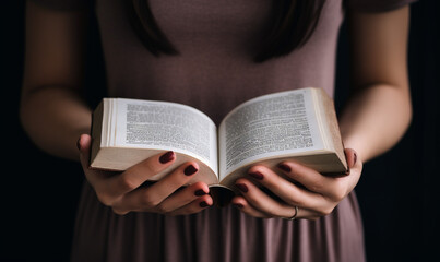 a hand woman reading a book