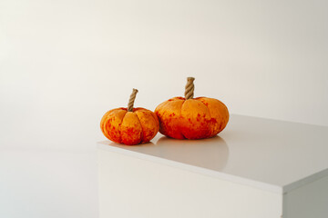 Orange decorative pumpkins are made of fabric. Autumn season