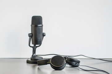 background: black microphone and headphones on the table