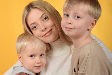 happy mother hugs her little sons