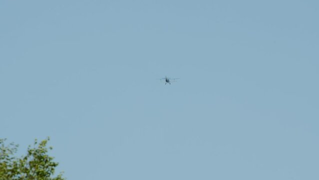 A biplane aircraft descending in the sky.