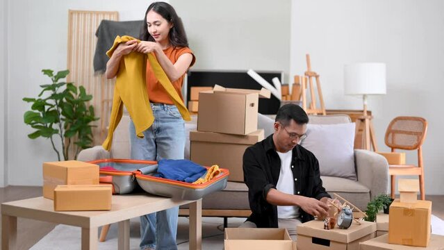 Happy asian young attractive couple man and woman with big boxes moving into a new house, new apartment for couple the new home, Moving house. .