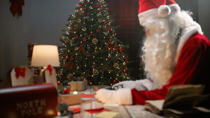 Santa scrolling and taking pictures with smartphone