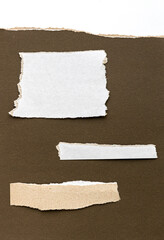 Paper different shapes scraps isolated on brown background White Ripped Piece of Paper isolated....