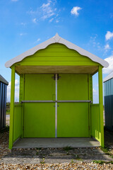 Brightly colored beach hut cabin at the English seaside. Traditional wooden beach hut 