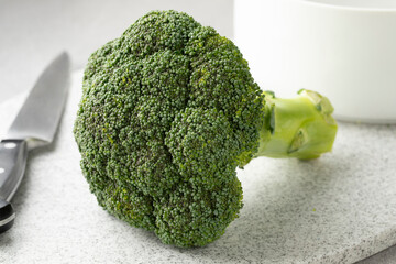 Fresh healthy green raw broccoli on a cutting board close up  