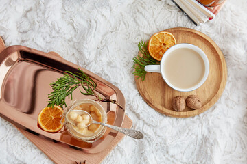 Festive Toffee hazelnut caramel spread and cup of coffee. Aesthetic Christmas table setting flat lay