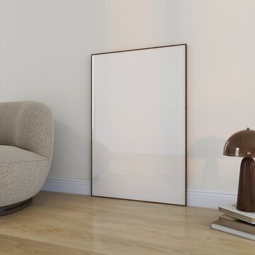Wooden frame mockup on wood floor with modern armchair, lamp and books. Empty canvas mock up scene template poster against wall. 3D render