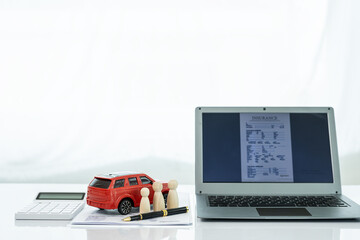 Business, Finance, Savings, Bank or Car Loan Concept: Small car models on the concept of blue car loans, calculators and laptops on the table. Financial concepts and car insurance