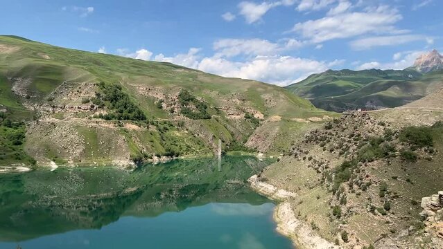 Turquoise lake Gizhgit in the village Bylym