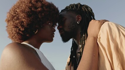 Closeup of a young African couple, deeply in love, embracing with intense eye contact, creating a moment of romantic connection