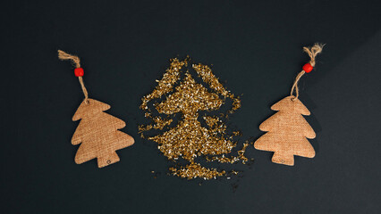 Golden sequins on a black background in the shape og Christmas tree. Abstract background with three...