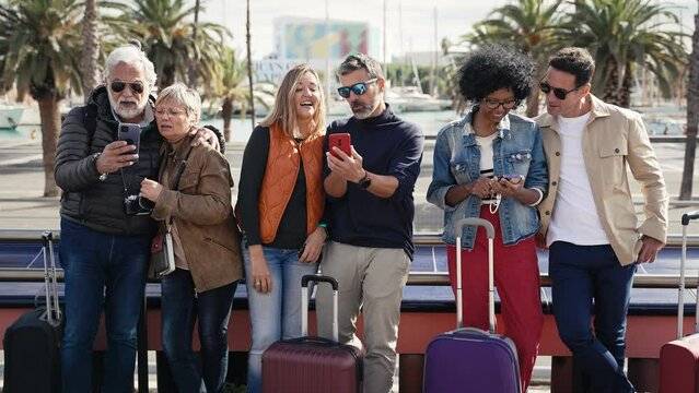 Group of tourists using cell phones in the city - Family friends traveling with smartphone app