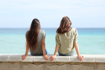Two women contemplating ocean on the beach