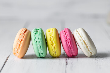French dessert colorful macarons on rustic background