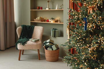 Stylish cozy home interior decorated for Christmas. Christmas tree and wrapped gifts in a modern...